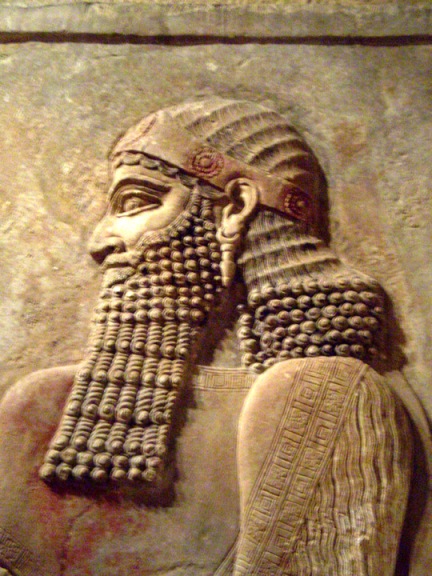 Proper Assyrian royal man with beard and rose head band.